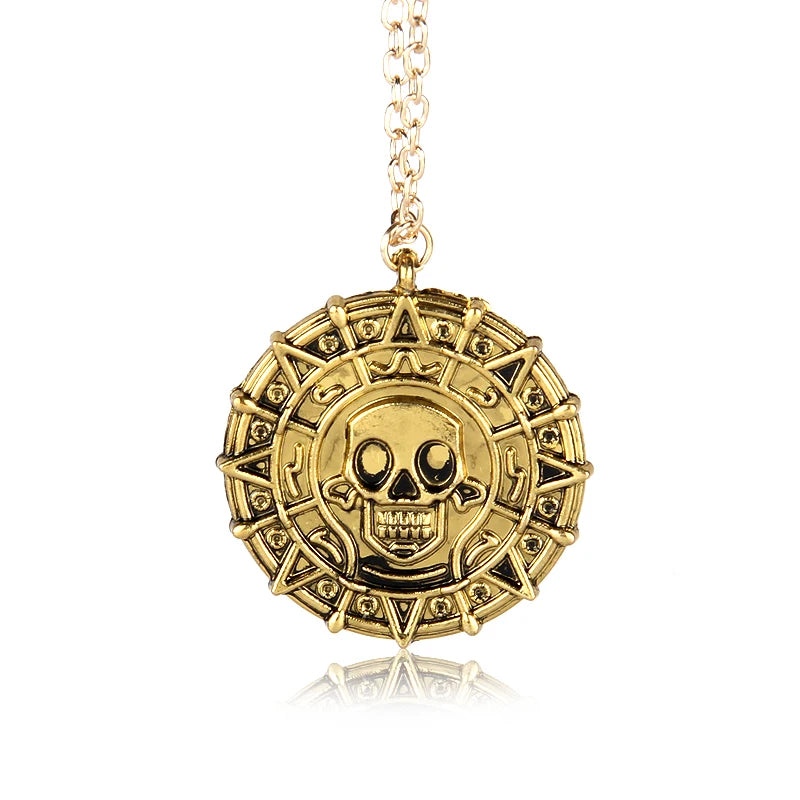 Gold skull pendant necklace with a chain hanging from it.