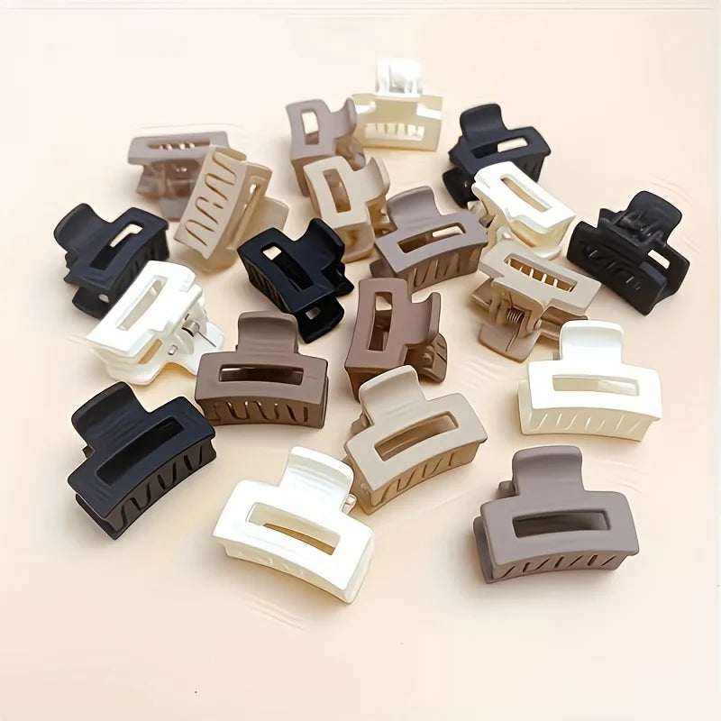 A collection of twelve rectangular hair clips in various shades of brown, black, and white.