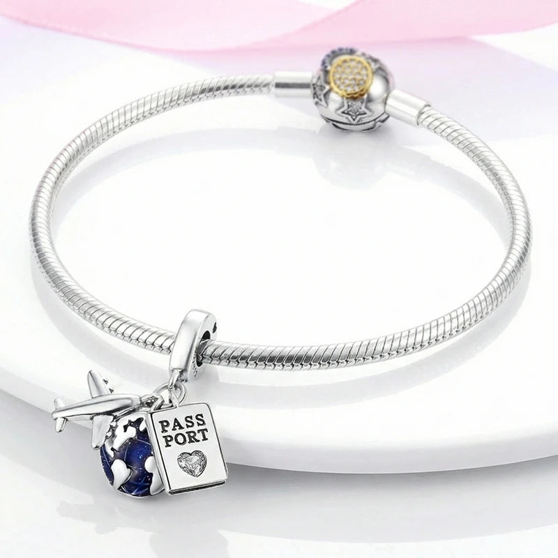 Sterling silver devil's eye charm bracelet with a round charm and a pass port pendant