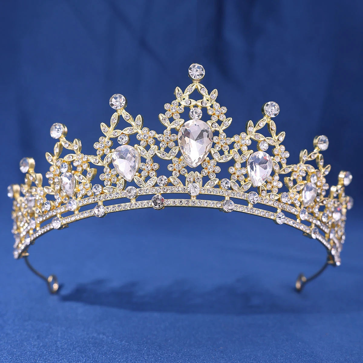 A golden crystal rhinestone tiara and headband set with intricate floral designs.