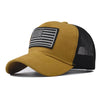 A tan tactical baseball cap featuring a black and white American flag design on the front panel.