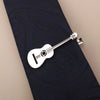 Silber-Titan-Krawattenclip in Gitarrenform, geklemmt auf blaues Stoff.