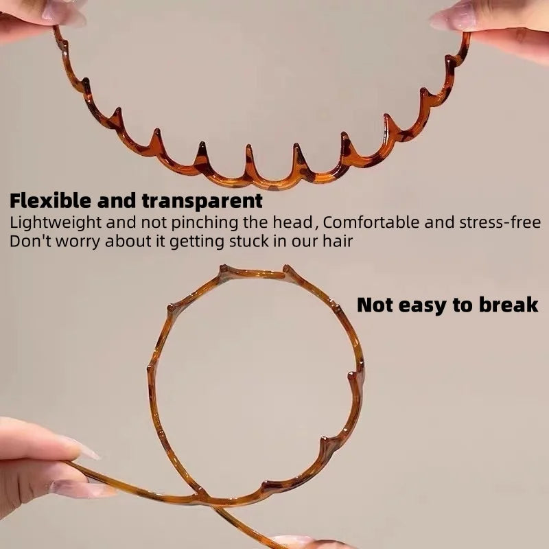 A flexible, transparent, textured hair band is shown being held by a hand.