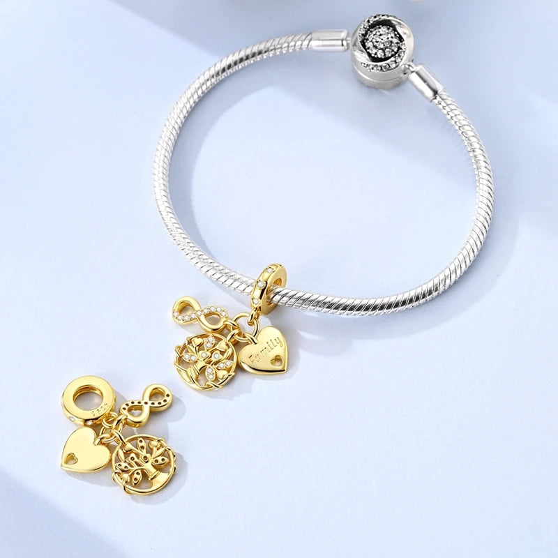 Sterling silver devil's eye charm bracelet featuring a circular pendant and multiple gold-toned charms