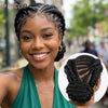 A smiling Black woman shows off short cornrow braided wigs for black hair.