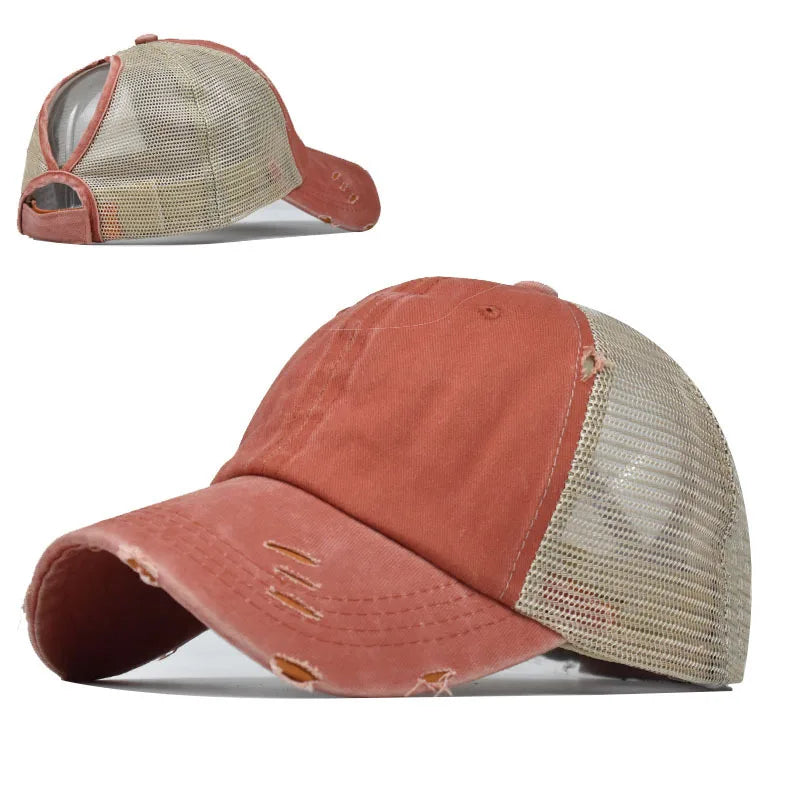 A vintage mesh baseball cap in a dusty rose color shown from the front and side.