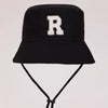 Black sun hat with a white letter R embroidered on the front and an adjustable cord.
