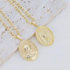 A gold plated pendant necklace featuring a detailed depiction of the Virgin Mary Christ on a gold oval charm.