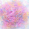 A pile of colorful disposable hair scrunchies in shades of pink, purple, and yellow.