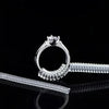 A silver ring sizer tool set featuring a ring and a corresponding adjustable band.