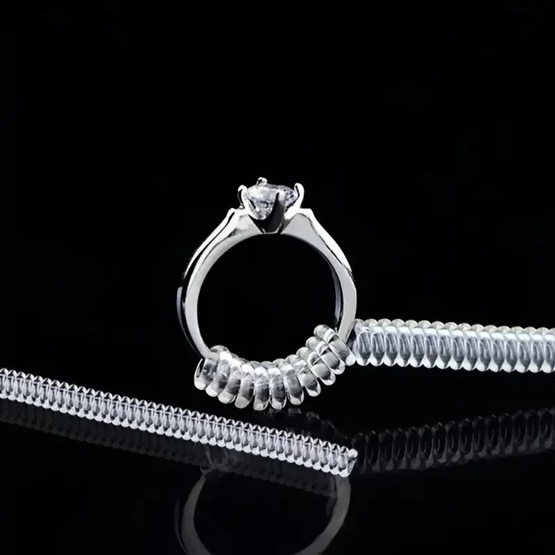 A silver ring sizer tool set featuring a ring and a corresponding adjustable band.