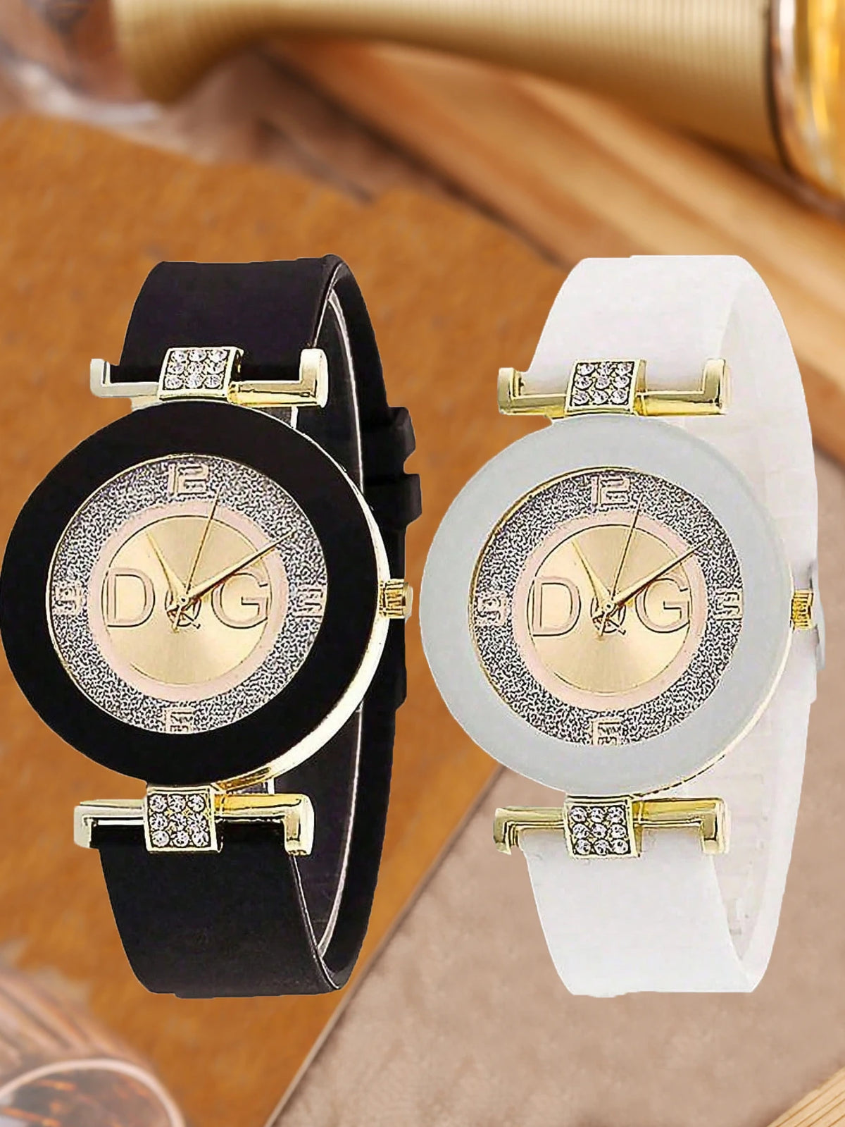 A black quartz wristwatch with a glitter dial and gold accents resting on a light brown surface.