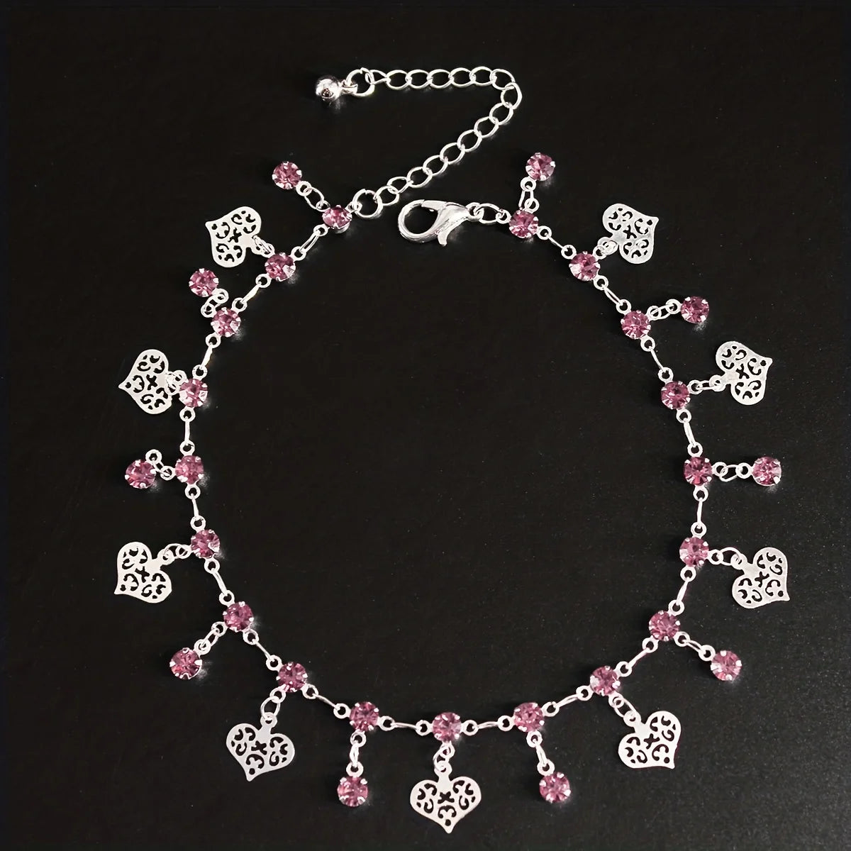 Silver stainless steel anklet featuring small pink rhinestone pendants.
