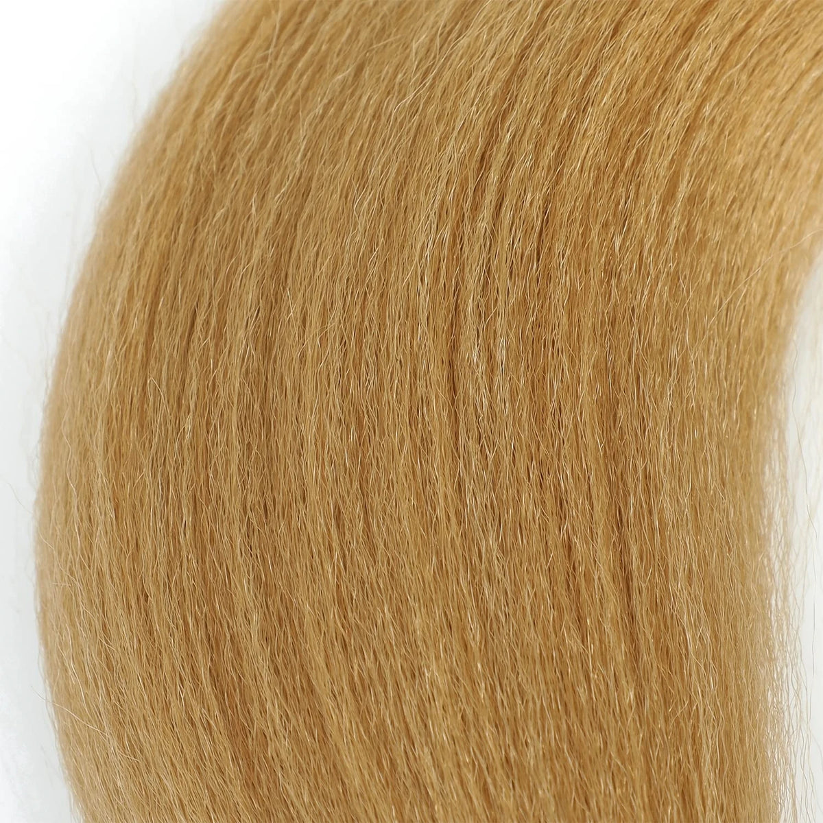 Close-up of pre-stretched Kanekalon braiding hair extensions in a light golden blonde color.