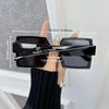 Black square mirror sunglasses being held by a hand, showing dimensions.