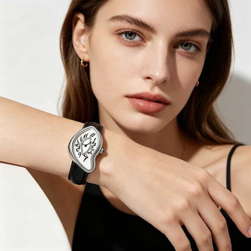 A close-up of a woman wearing a silver and black vintage irregular quartz watch on her wrist.