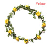 A wreath of yellow flowers and green leaves used as a bohemian flower headband for women.