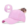 A bright pink breathable mesh criss-cross baseball cap worn by a person.