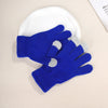 A pair of blue knit touch screen gloves with gray accents resting on a white silicone pad.