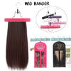 A wig hanger displaying a long, dark brown hair extension and several colored wig clips.