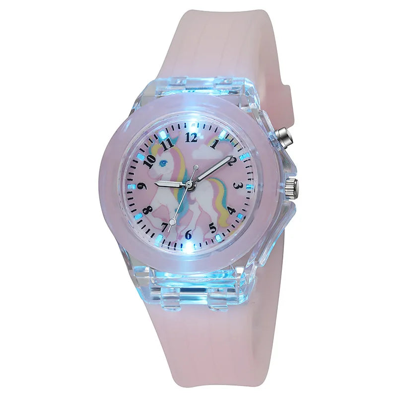 A pink fashion watch featuring a clear crystal face with a unicorn design and a light pink strap.