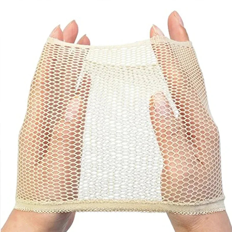 A hand is holding a natural nude black wig cap for long hair, showing the mesh netting and fabric.