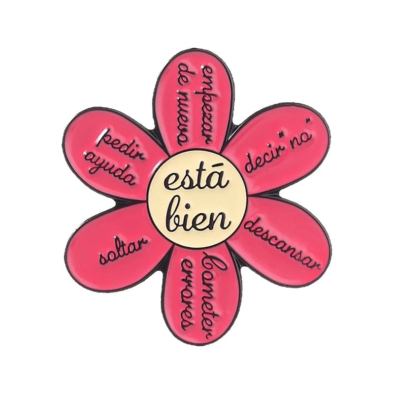 A set of enamel flowers with Spanish phrases like pedir ayuda and descansar
