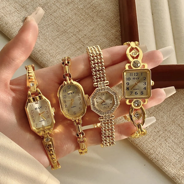 A hand holds four gold-toned quartz fashion wristwatches against a neutral background.