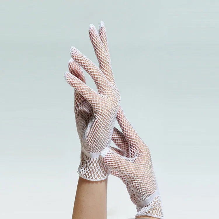 A close-up of sheer lace fishnet evening gloves worn on a hand.
