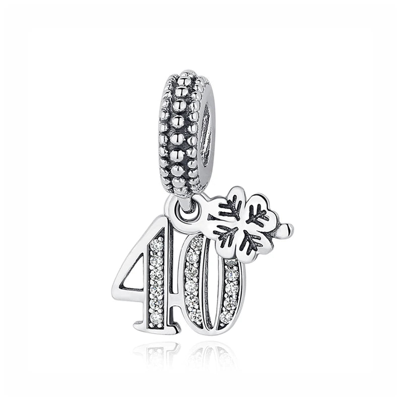 Silver charm featuring the number 40 and a family tree design, set in a beaded bail.