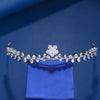 A sparkling cubic zirconia bridal tiara headband displayed on a blue velvet box.