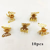 A set of ten gold-colored mini hollow butterfly metal hair clips displayed on a white background.