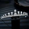 A sparkling cubic zirconia bridal tiara headband displayed on a black surface.