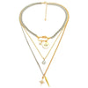 A multilayered gold and silver pendant necklace featuring a star eye charm.