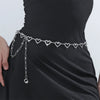 Silver heart chain body jewelry worn around the waist of a black dress