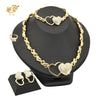 A gold heart crystal jewelry set featuring a necklace and pair of earrings displayed on a black stand.
