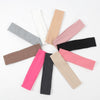A collection of ten knitted elastic headbands in various shades including pink, beige, gray, and black.