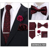 A set of men's formal accessories including a maroon patterned tie, bow tie, and boutonniere on a black suit jacket.