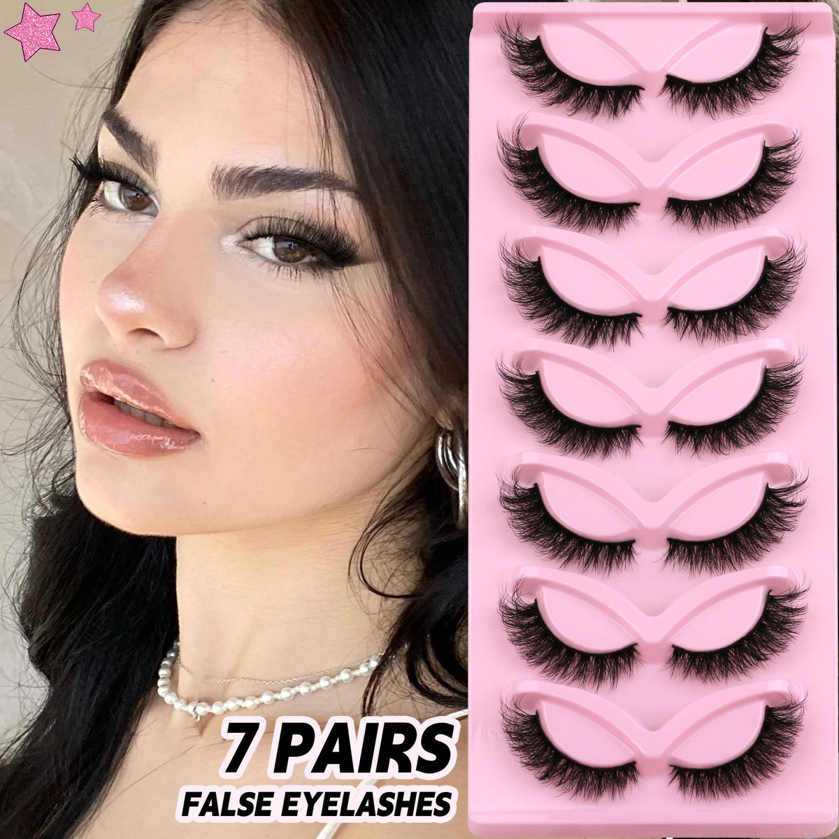 A display of 7 pairs of false mink cat eye eyelashes in a pink plastic tray.