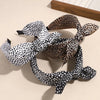A collection of leopard print retro bow hairbands in black and white patterns.