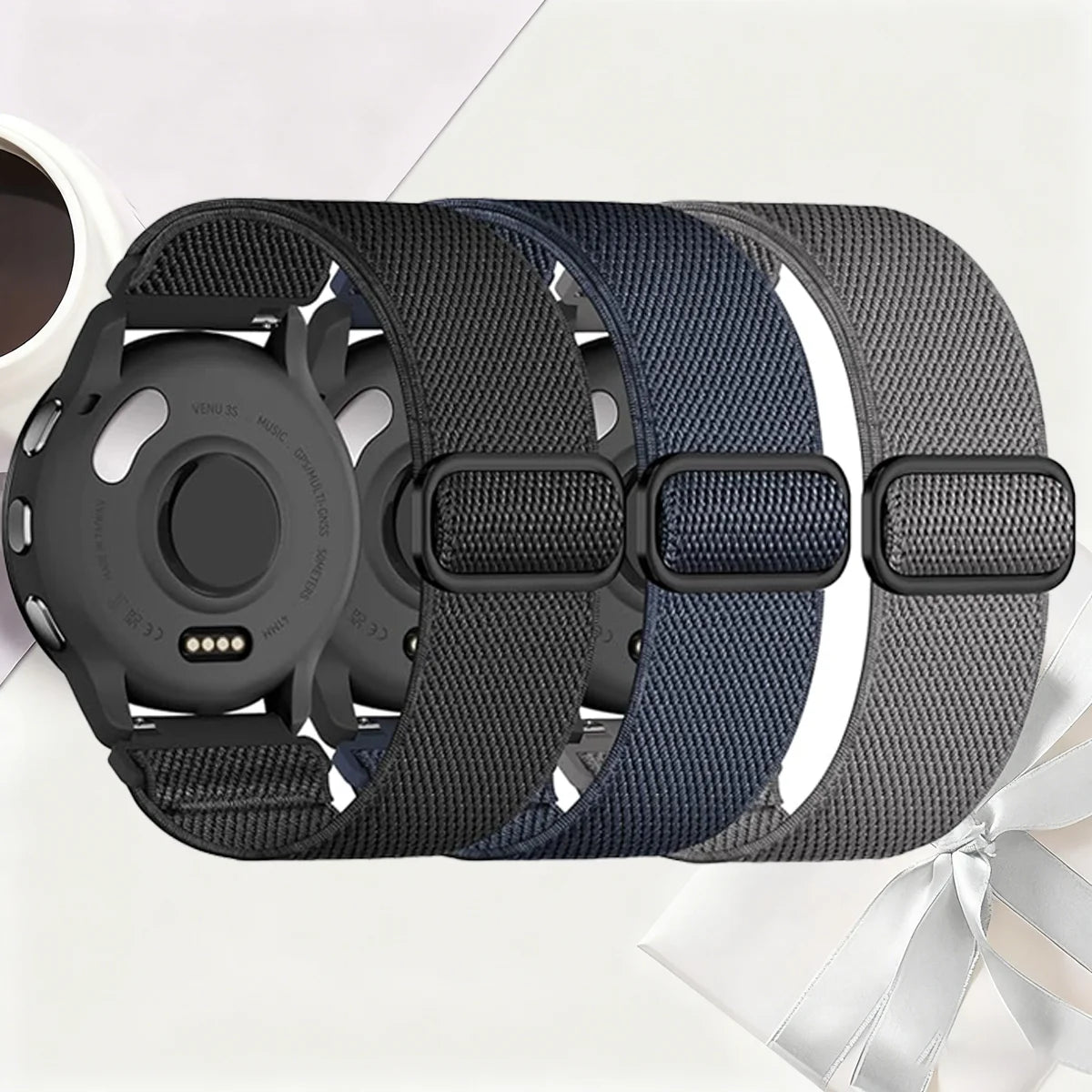 Black and blue stretchy nylon watch bands for Garmin devices displayed on a white surface.