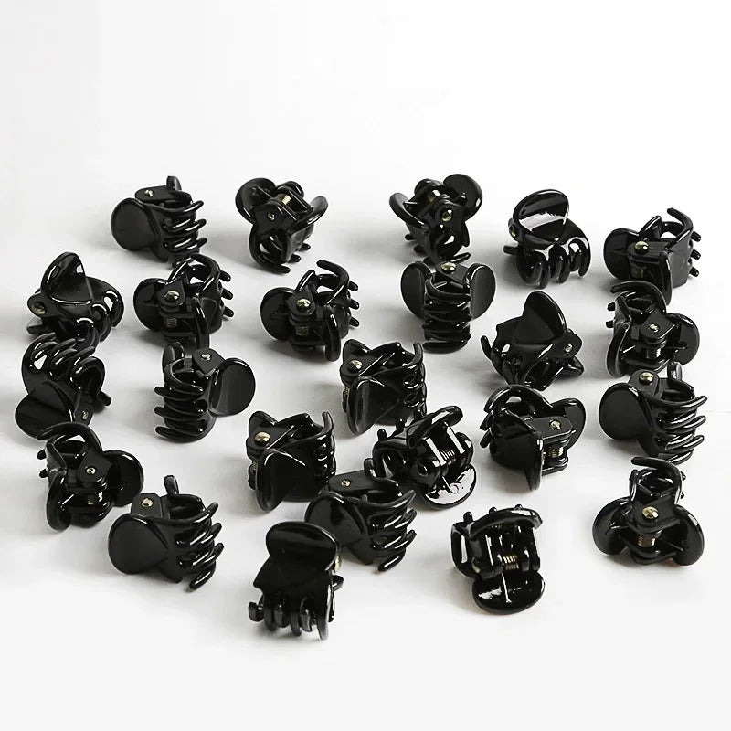 A set of black adjustable hair claw clips displayed on a white background.