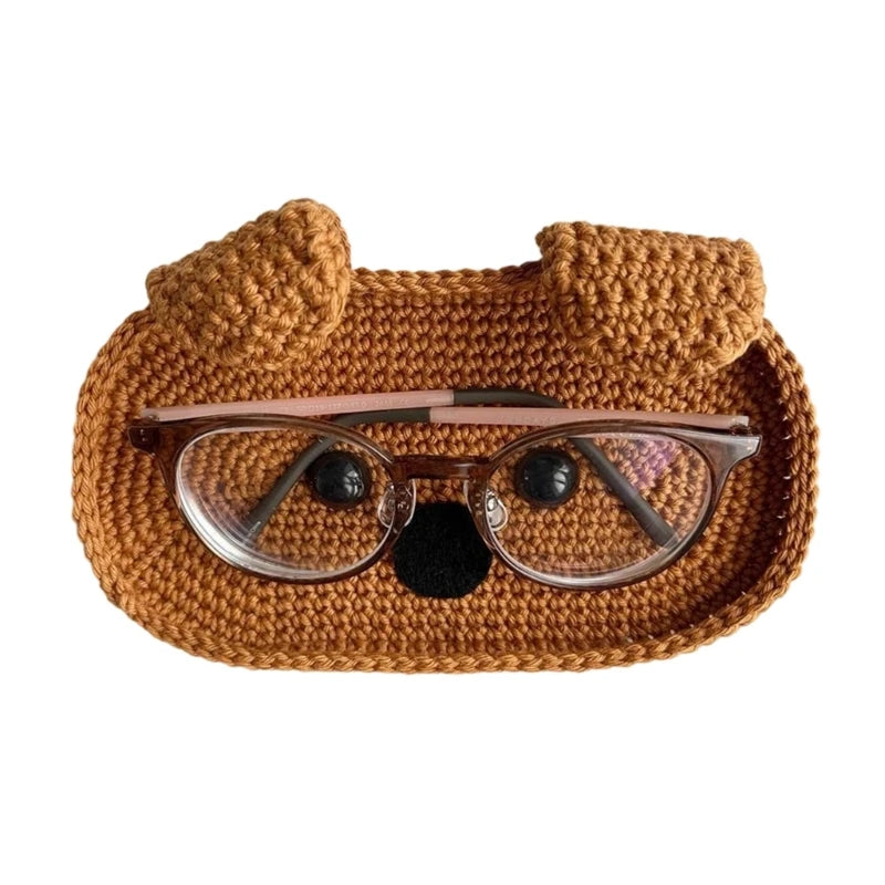Handmade crochet animal storage case in brown yarn shaped like a bear, designed to hold eyeglasses.