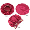 A set of three satin sleep bonnets in deep pink featuring floral embroidery, shown from front, back, and side views.