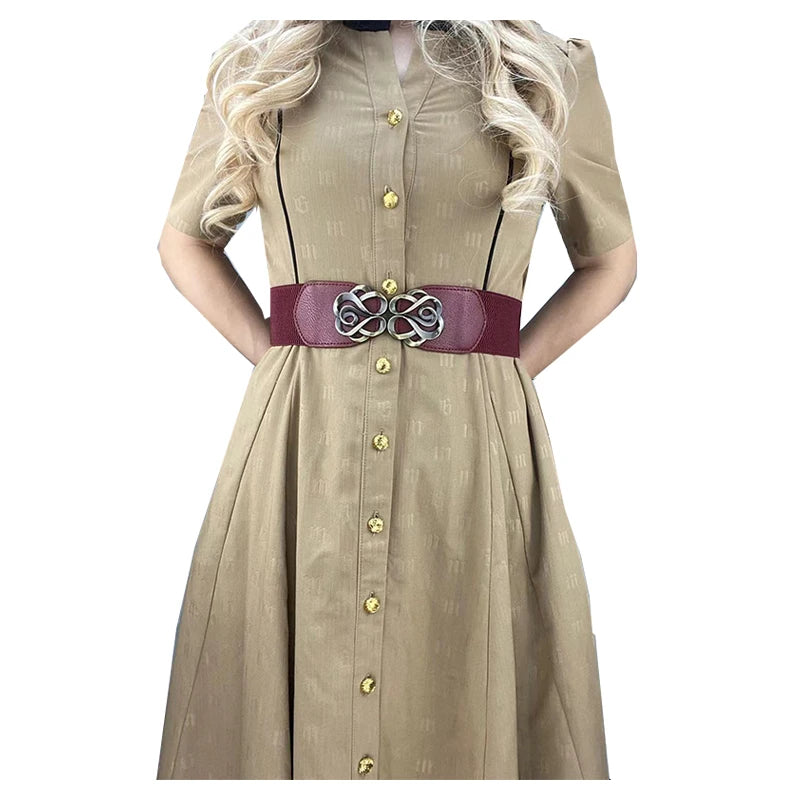 A beige vintage leather dress with a dark purple belt and brass buckle.