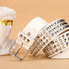 A close-up of a beige leather belt adorned with silver metal rivets and studs, displayed next to a white bust.