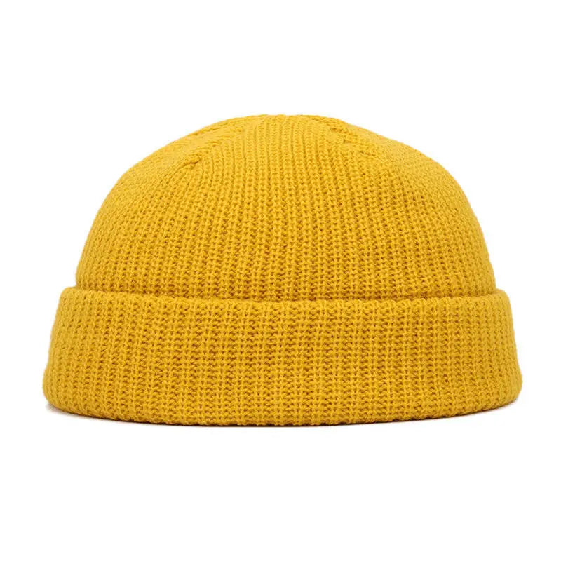 A bright yellow knitted beanie cap with a ribbed cuff.