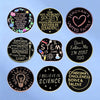A collection of black and gold lapel pins featuring inspirational quotes related to faith, reading, happiness, science, and t