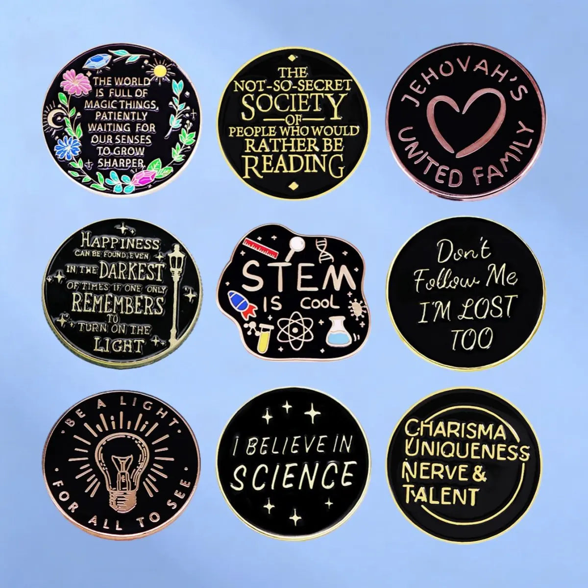 A collection of black and gold lapel pins featuring inspirational quotes related to faith, reading, happiness, science, and t