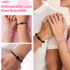 Close-up of hands wearing pinky promise love knot bracelets for couples on wrists.